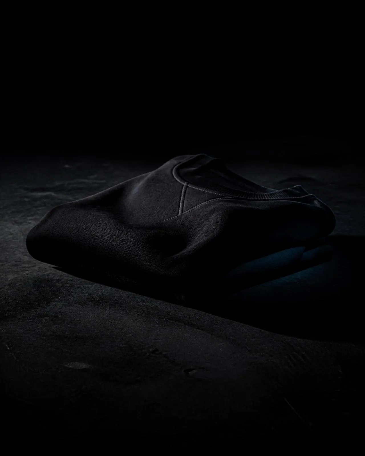 Flux District garment detail photographed in low industrial light